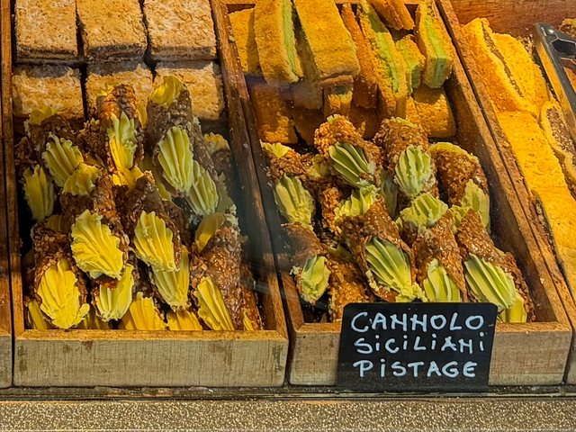Cannoli siciliani med pistage i trälådor, med griffeltavlan Cannolo siciliani pistage